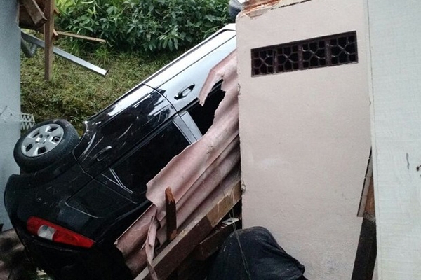 Carro cai em ribanceira e atinge telhado de duas casas em Blumenau